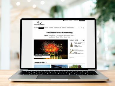 Lokalmatador Auf einem Schreibtisch liegt ein Tablet mit geöffneter Lokalmatador Webseite. Eine Person scrollt.